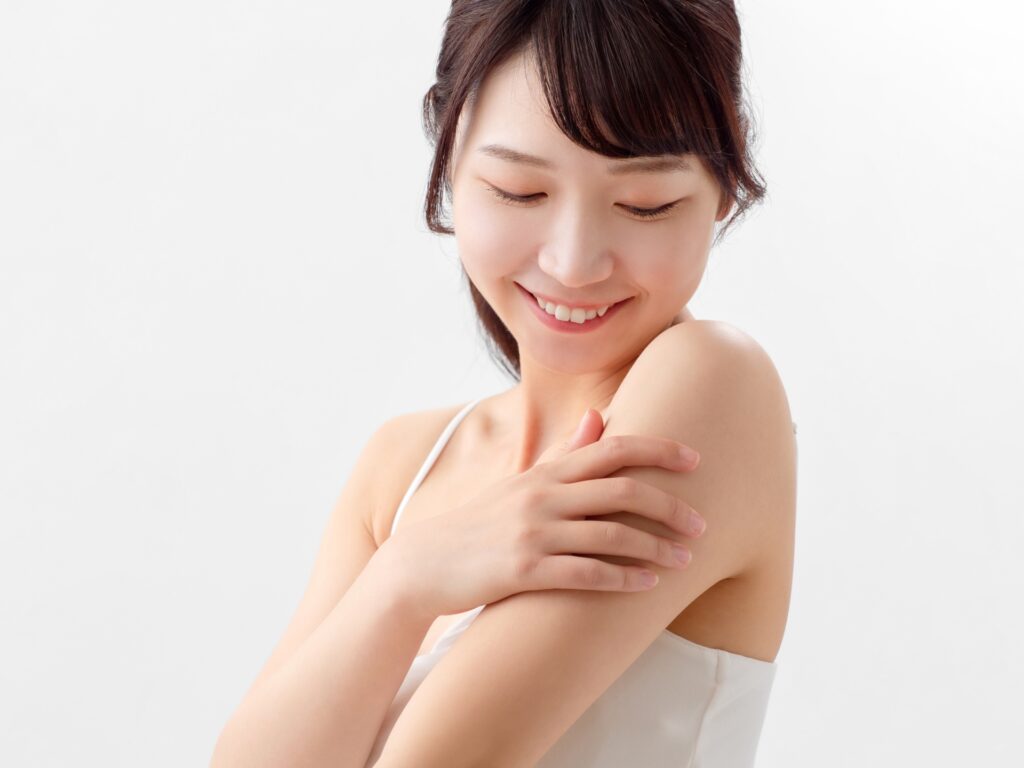 肌を見て微笑む女性